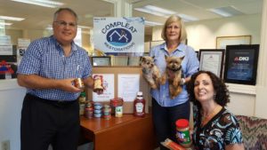 compleat restorations team with dogs and snacks