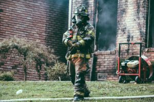 firefighter exiting burning building