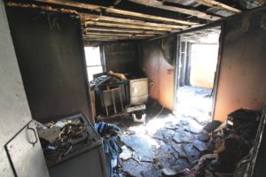 trrashed room with fire damage