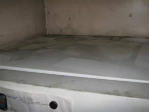 a dirty white surface in a cabinet