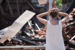 woman shocked at burned down house