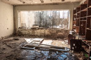 Water pouring down on wall in abandoned room in pripyat