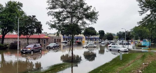 Flooded street with cars littered throughout
