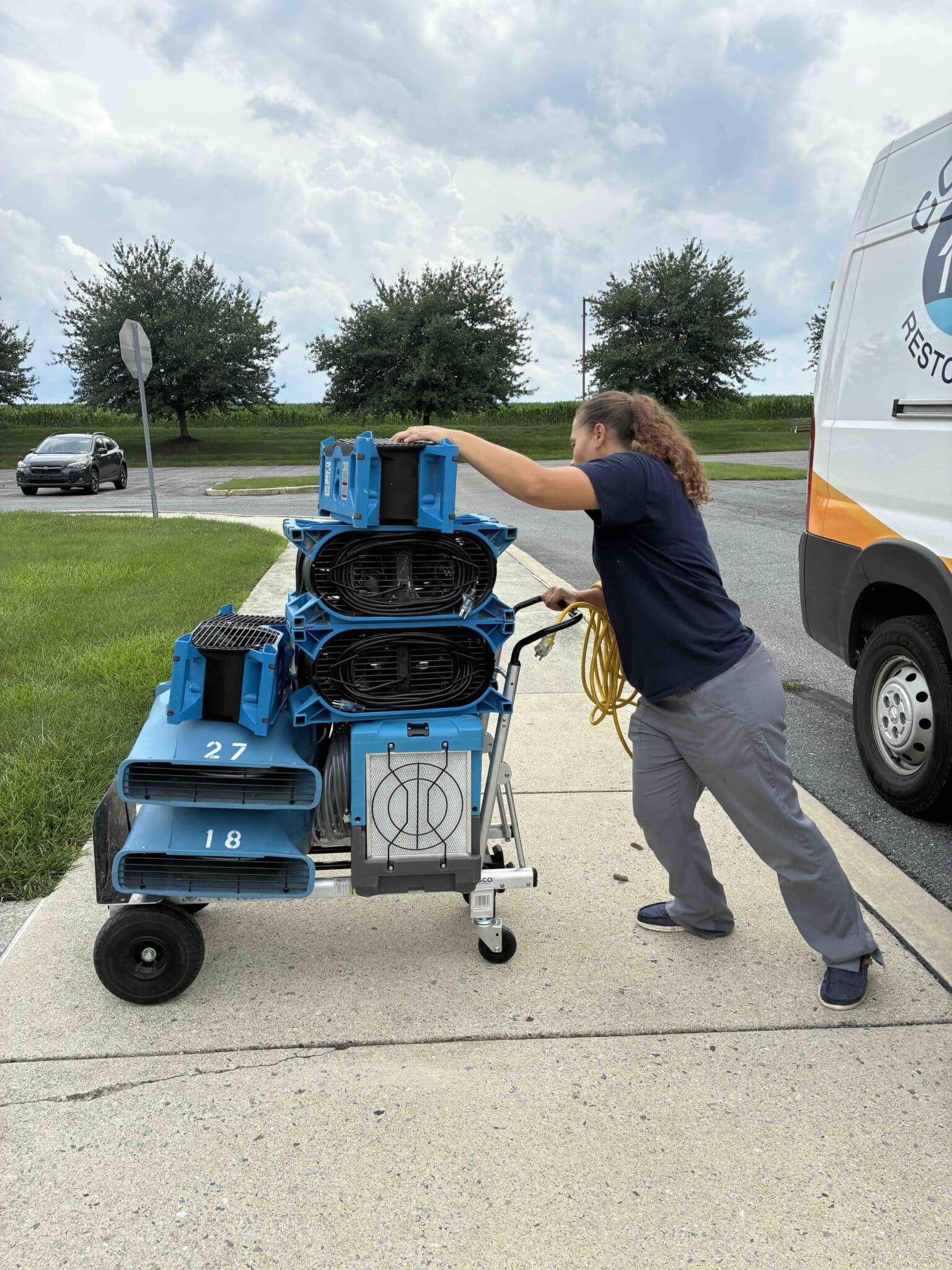 woman moving water restoration equipment in Ephrata