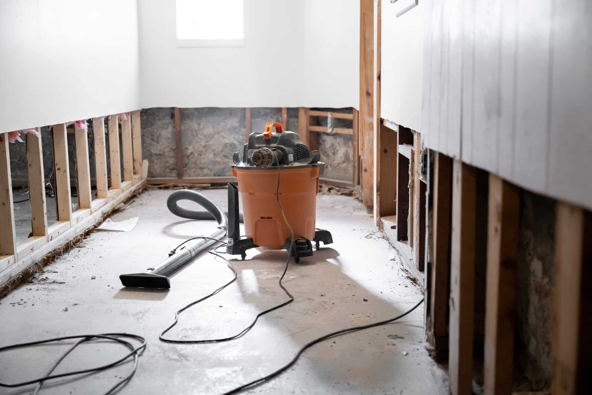 water damage restoration equipment in damaged room