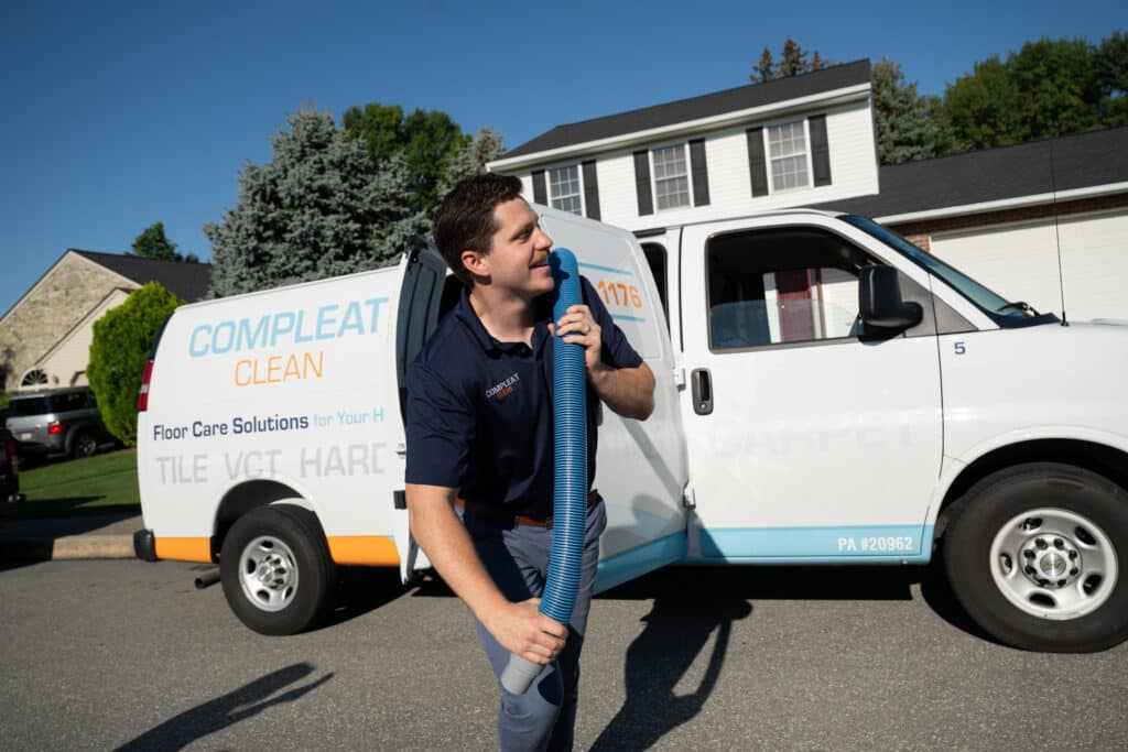 Compleat Restorations team member with floor care equipment