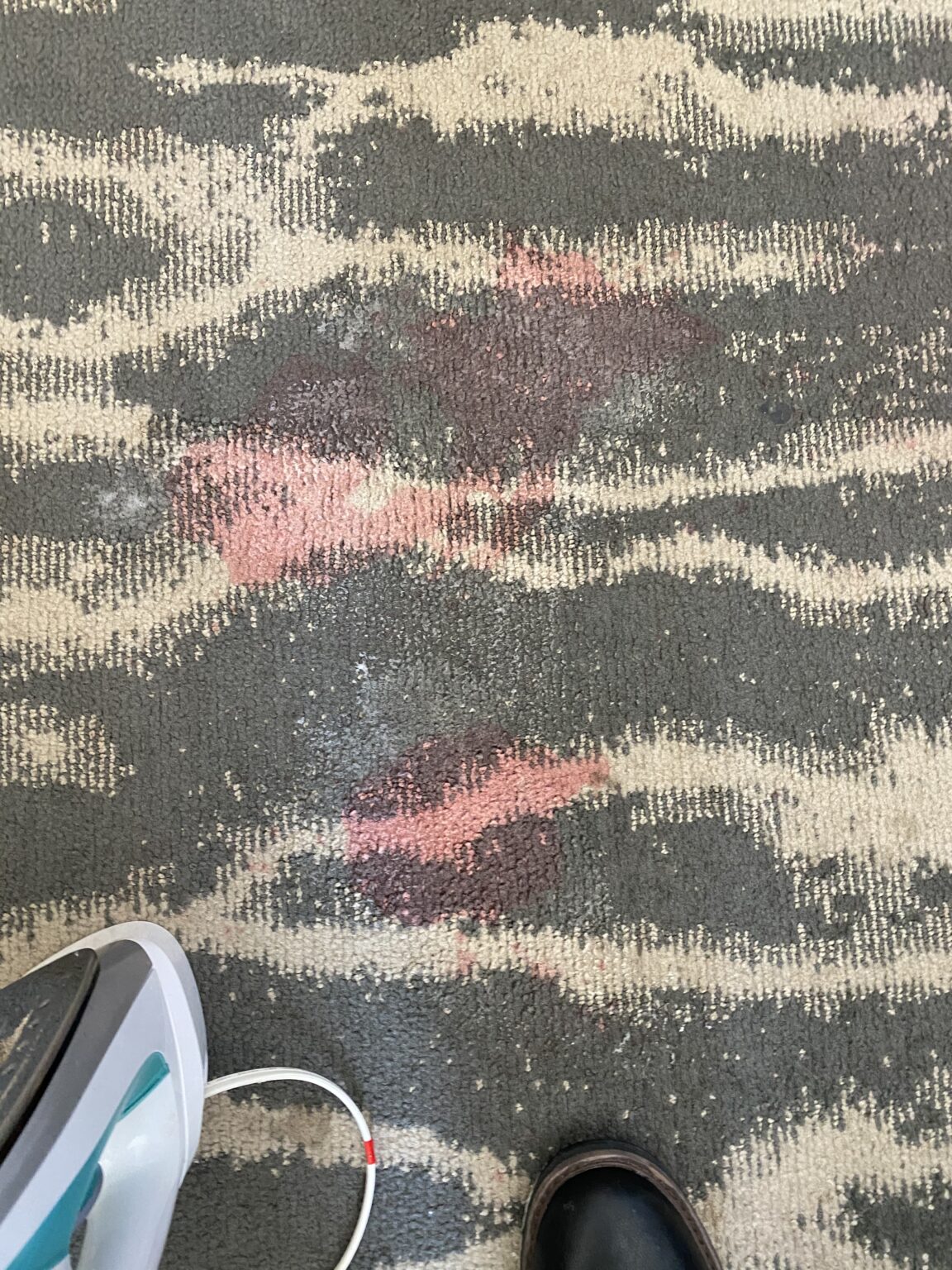 Commercial carpet with red stains before cleaning