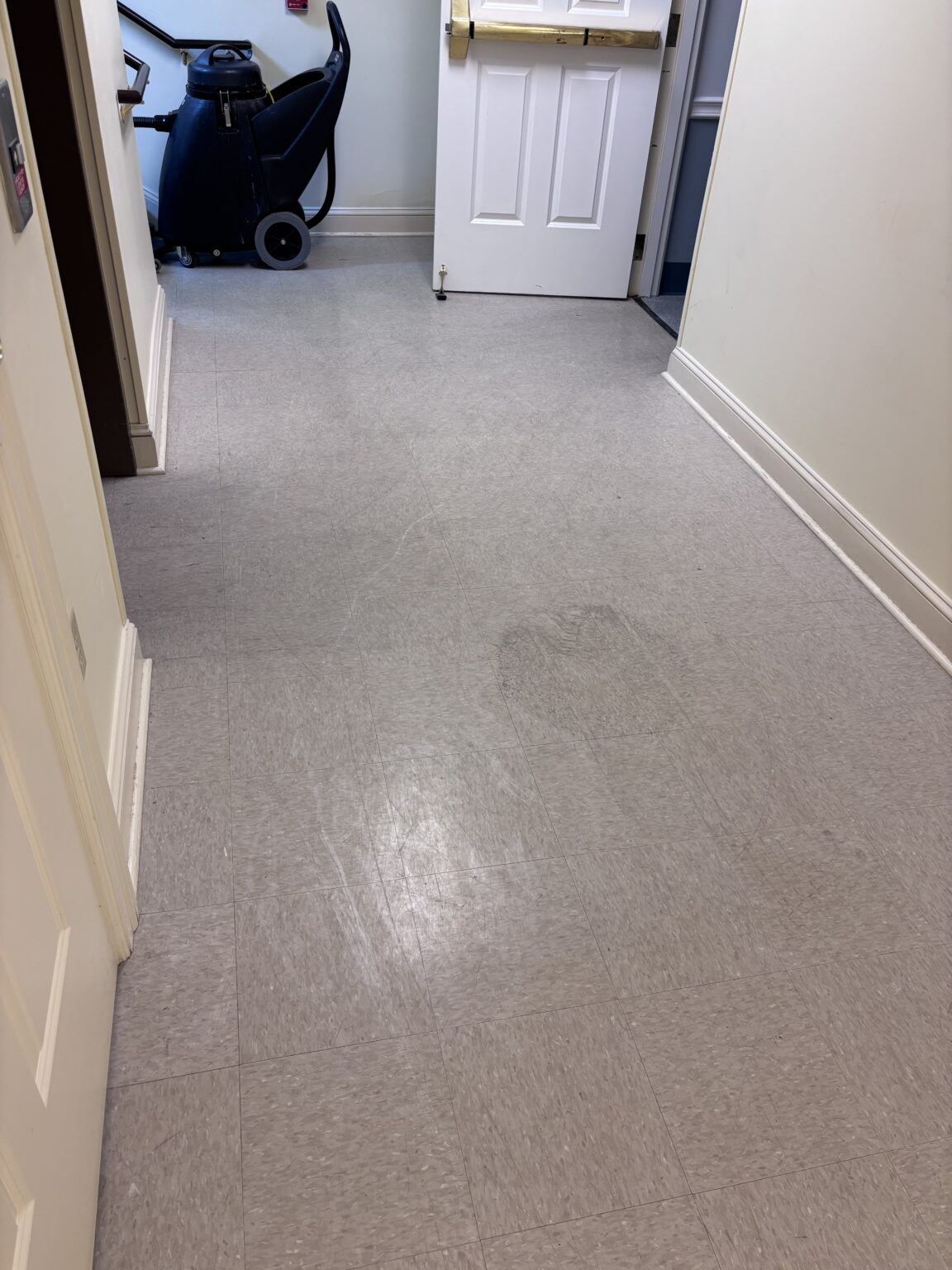 Dull, scuffed tile floor before cleaning